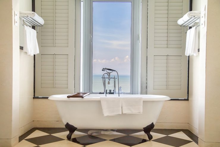 Luxury bathtub with relaxing ambient window with scenic sea vie