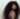 Confident Black woman with long natural curly hair looking over shoulder, expressing bold self-identity and style