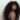 Confident Black woman with long natural curly hair looking over shoulder, expressing bold self-identity and style