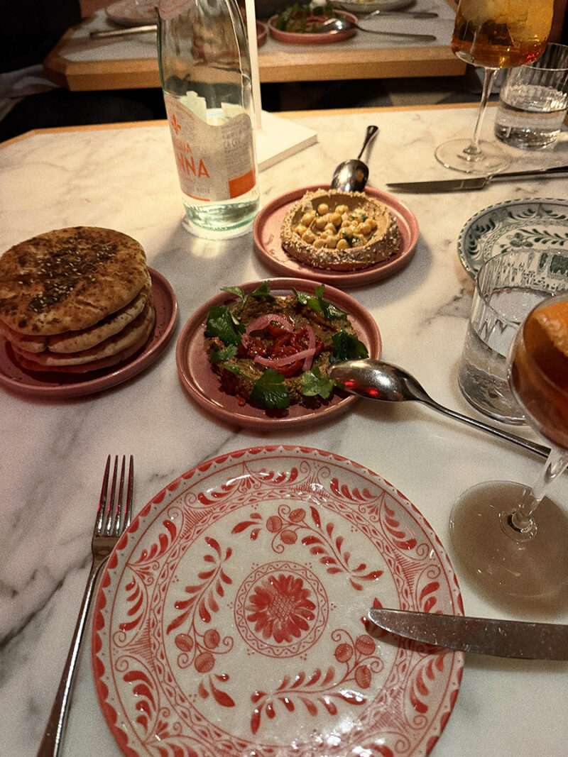 Mediterranean spreads with warm pita including black garlic hummus beet tzatziki and baba ghanoush at Leonetta 