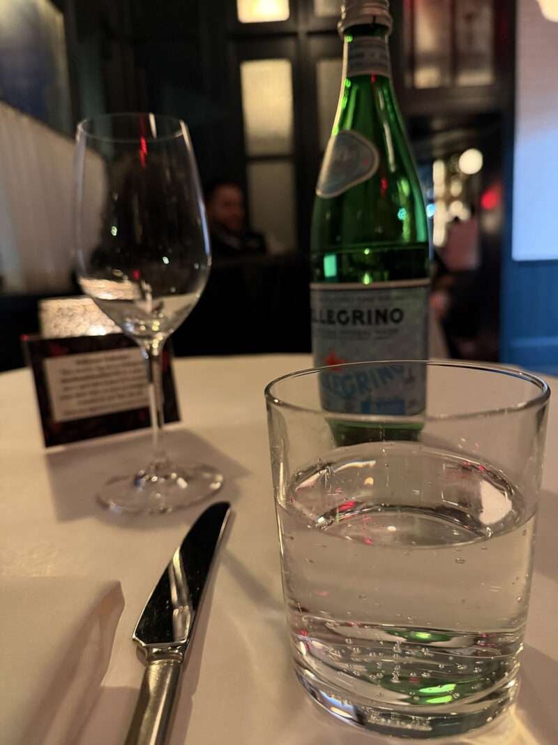 west-village-jack-charlies-water San Pellegrino water and wine glass on white linen table at Jack & Charlie’s No. 118.