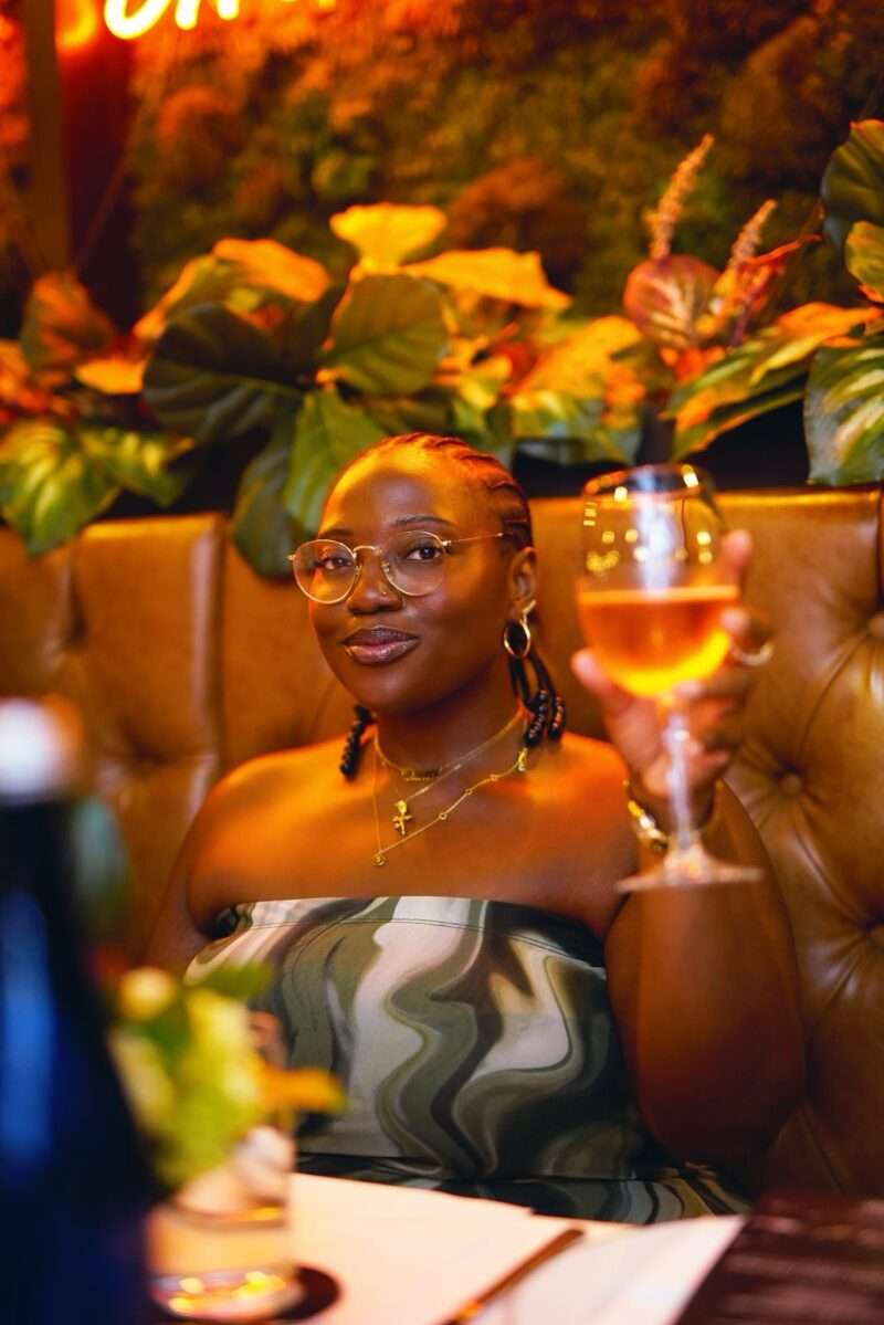 Guest raising a glass of champagne at the Brooklyn Chop House dinner